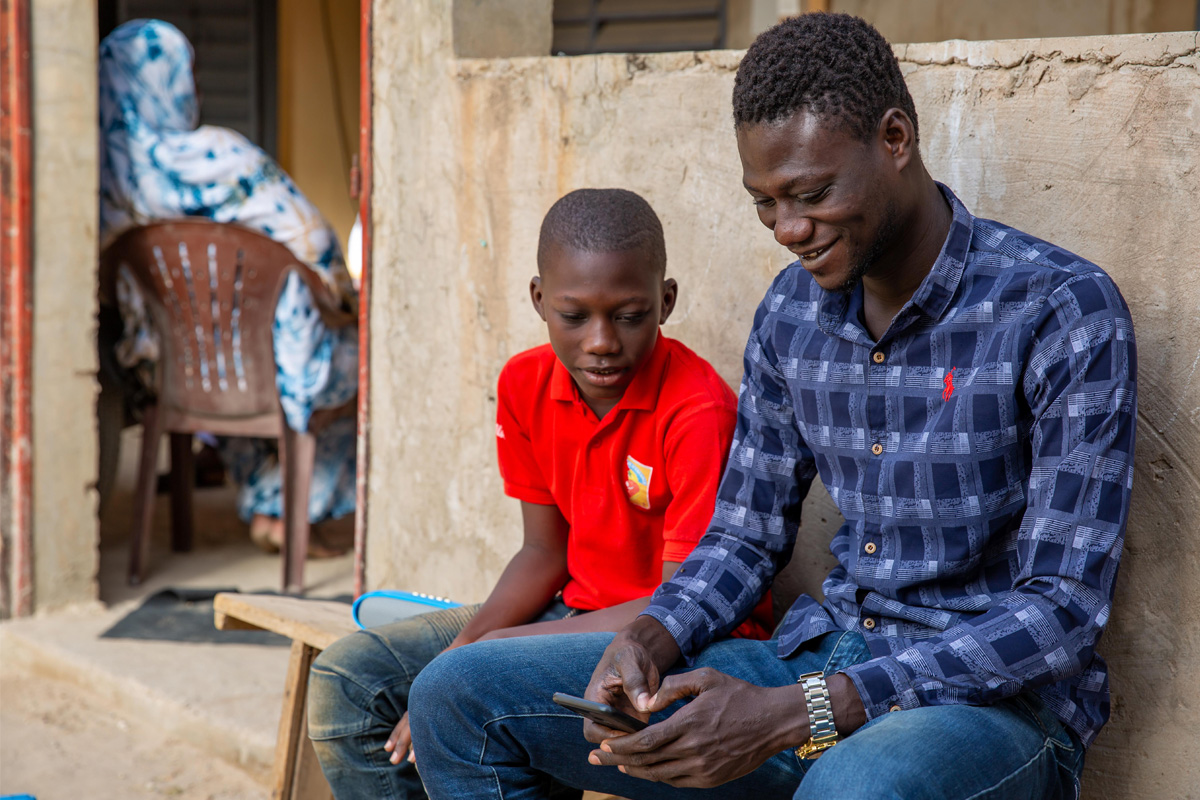 Young men in Africa on their phone