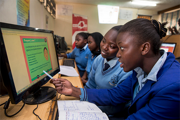 girls looking at computer in Africa