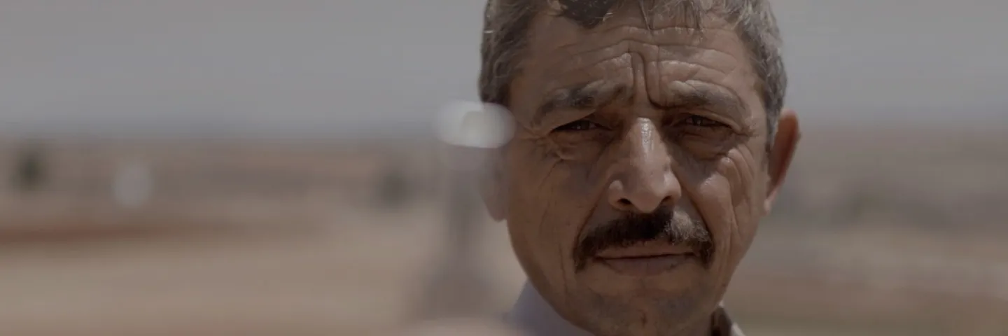 Man holding a medicine vial in the sunny desert