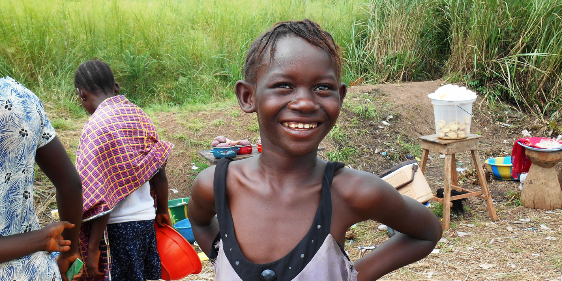 A girl smiles among vendors at a roadside Ebola check point in Port Loko Sierra Leone. 