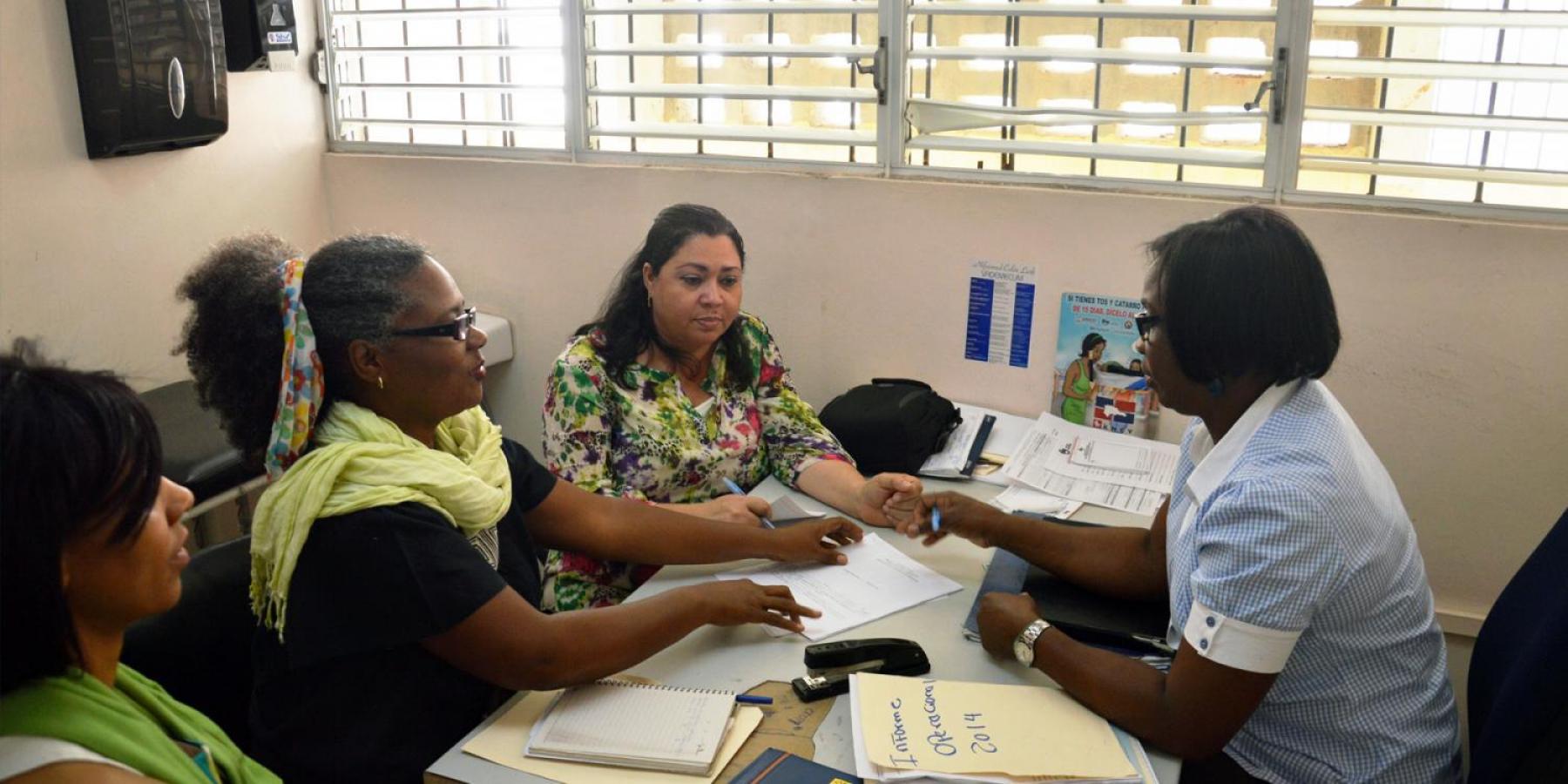 Patients speak with a health professional at an integrated care clinic in the Dominican Republic.