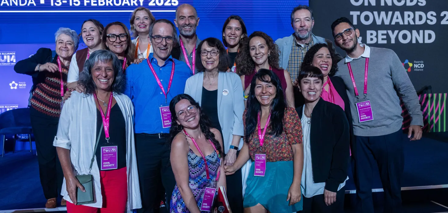 Global NCDA Forum delegates smiling on stage