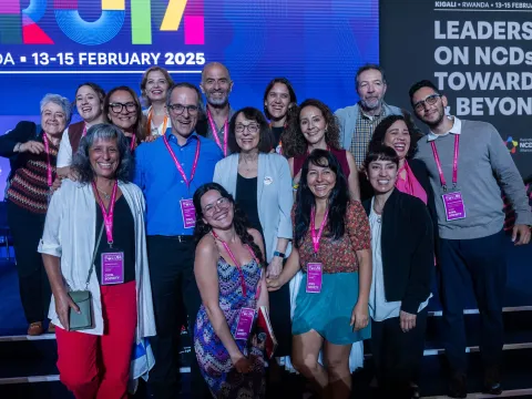 Global NCDA Forum delegates smiling on stage