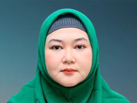 Woman of asian descent in headscarf smiling at camera