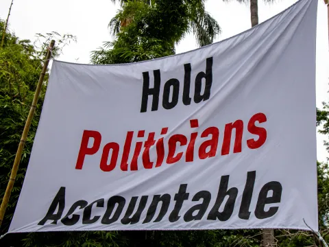 Protest sign with 'hold politicians accountable' on it