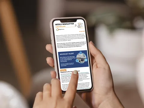 person reading NCDA newsletter on phone