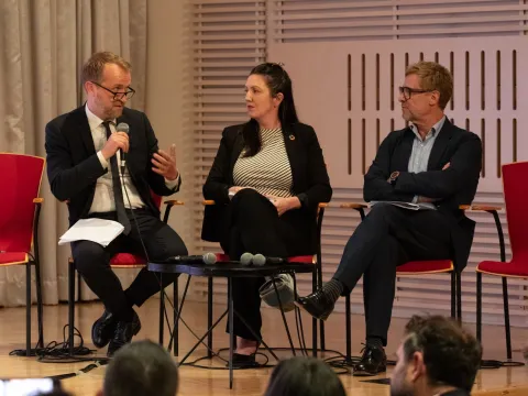 Bent Lautrup-Nielsen, NCDA President Leslie Rae Ferat and Guy Fones speaking on stage