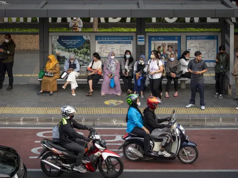 Commuters wait for public transportation in Jakarta, Indonesia on November 7, 2023.