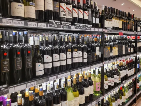 Supermarket aisle stocked with diverse wine bottles