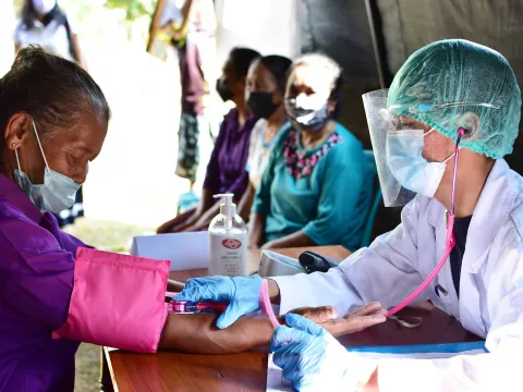 Doctor examining sick patient in face mask