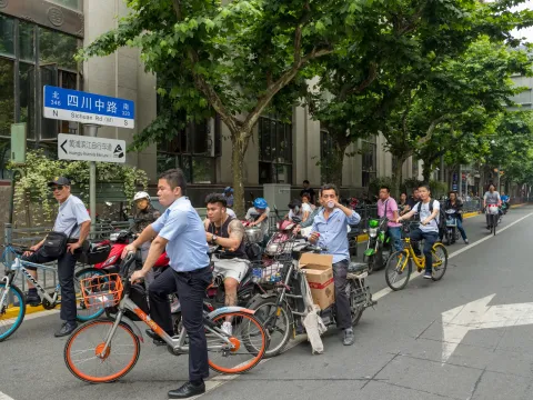 A group of cyclicts at a busy junction in Shanghai, China