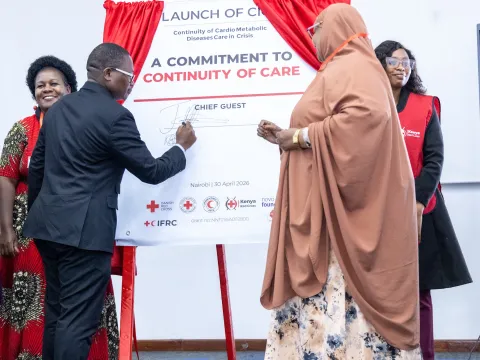 Politician signs "Commitment to continuity of care" banner in Kenya