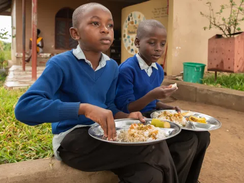 Children eating at a school in Tanzania