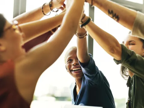 Group of women stretch at work