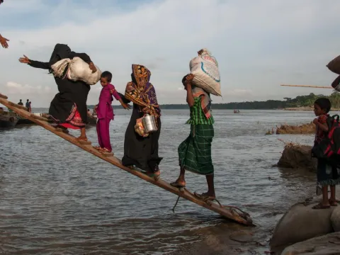  Climate-affected internally displaced persons board a boat to travel to Dhaka, Bangladesh. 