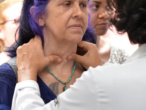  Health professional in Brazil examines possible thyroid nodule in a patient