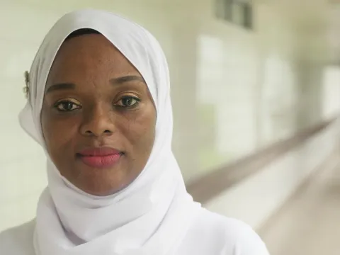African woman in white sari smiling 