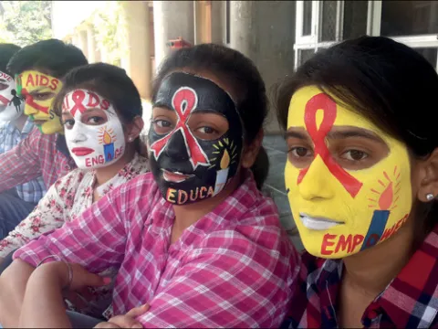 Students recognise International AIDS Candlelight Memorial Day with painted faces at the Centre for Social Work, Panjab University, Chandigarh, India. 