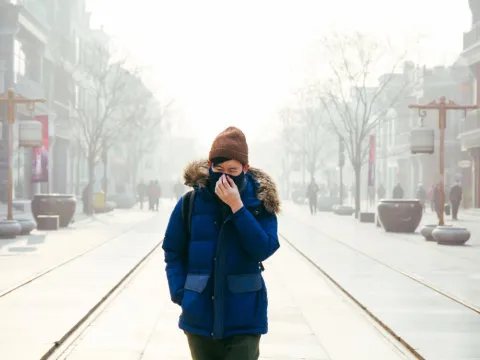 Man walking in Beijing air pollution
