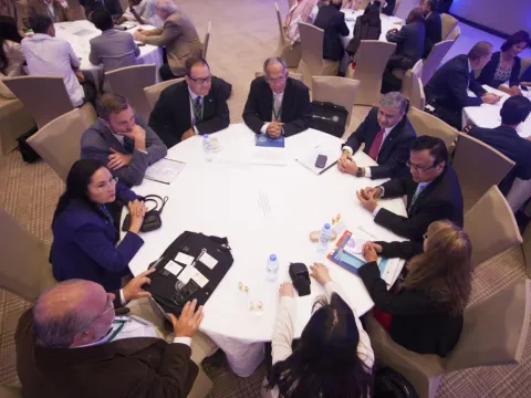 Group of people around a table in discussion
