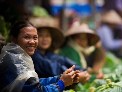 Women in south east asia selling vegetables at a market