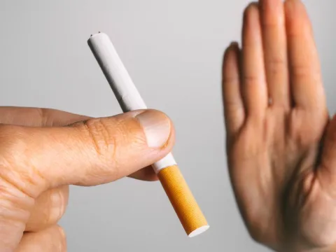 Someone declining a cigarette