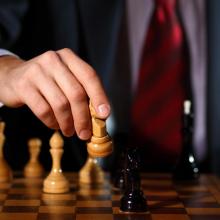 Business tactics playing chess