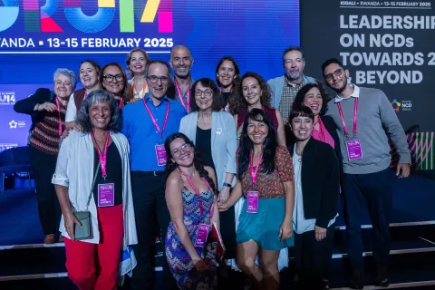 Global NCDA Forum delegates smiling on stage