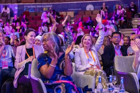 Delegates raising their hands at the global forum