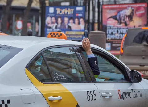Smoking out of a taxi window in a traffic jam