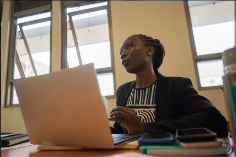 A woman in Uganda in front of computer