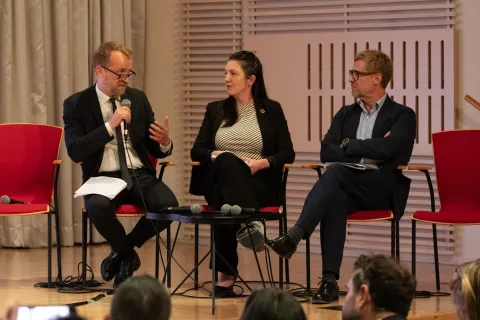 Bent Lautrup-Nielsen, NCDA President Leslie Rae Ferat and Guy Fones speaking on stage