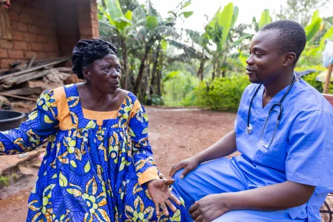 A rural doctor talks to an elderly patient during a medical examination 