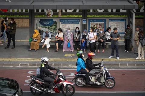 Commuters wait for public transportation in Jakarta, Indonesia on November 7, 2023.
