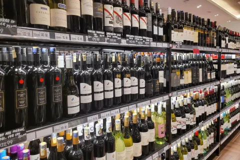 Supermarket aisle stocked with diverse wine bottles
