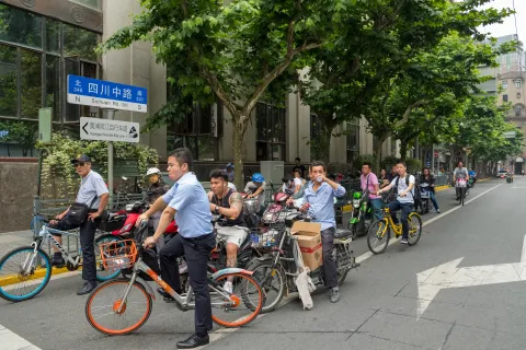 A group of cyclicts at a busy junction in Shanghai, China