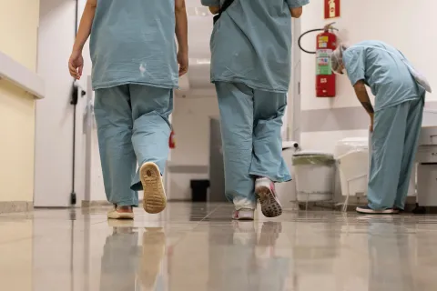 hospital health workers walking in scrubs