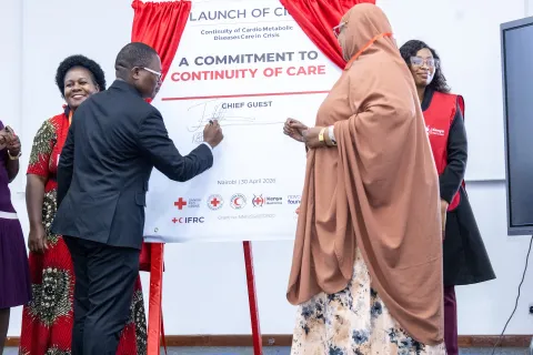 Politician signs "Commitment to continuity of care" banner in Kenya
