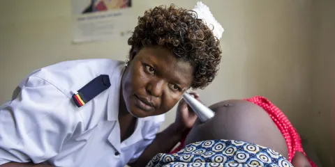 Head antenatal nurse Margie Harriet Egessa providing antenatal counseling and checkups for a group of pregnant women.