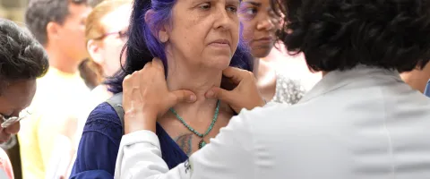  Health professional in Brazil examines possible thyroid nodule in a patient