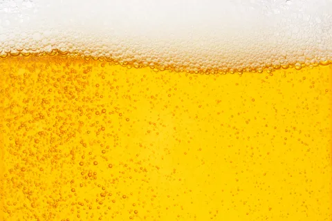 Close-up of beer showing amber-coloured liquid with bubbles