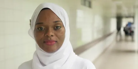African woman in white sari smiling 
