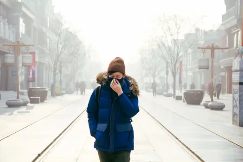 Man walking in Beijing air pollution