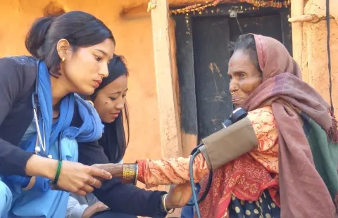 Community health workers check the blood pressure of a woman with breathing difficulties, Achham district, Nepal, Feb 2018
