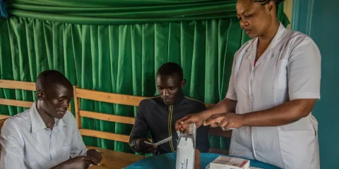 Kamayirese Odette, a nurse at the Imbuto Foundation (Rwanda), trains two community volunteers