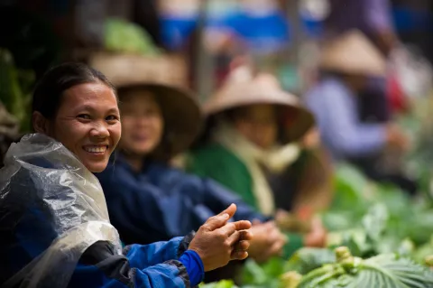 Women in south east asia selling vegetables at a market