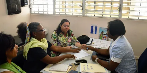 Patients speak with a health professional at an integrated care clinic in the Dominican Republic.