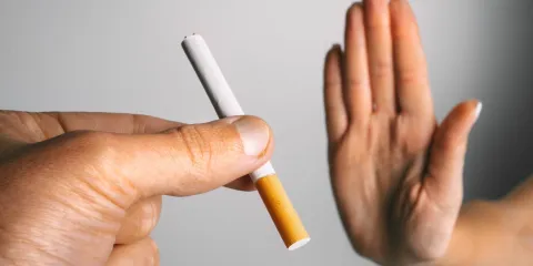 Someone declining a cigarette