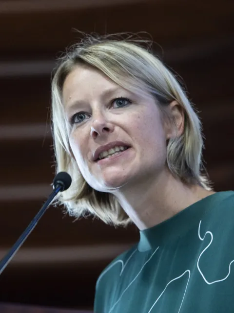 NCDA CEO Katie Dain at a microphone speaking at FAO Event in Rome