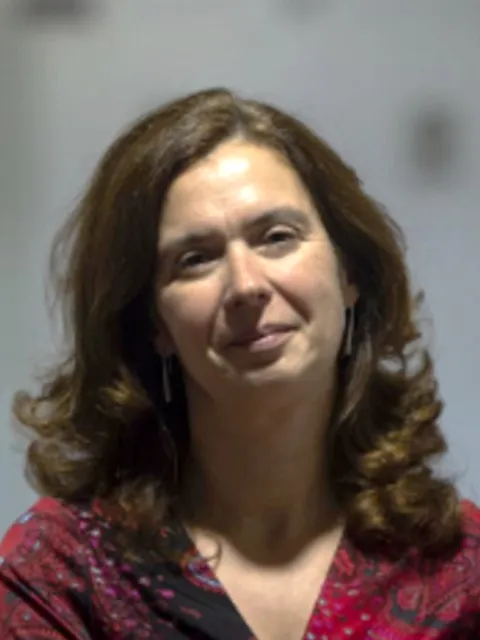 woman smiling at camera with red shirt on
